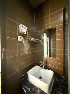 a bathroom with a sink and a mirror at PAI Hotel Chengde Pingquan Central Square in Chengde