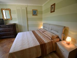 a bedroom with a bed and a dresser and a lamp at Nature Retreat in Testico in Testico