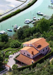 an aerial view of a house with boats in the water at Villa Saline Apartments Portorož in Portorož