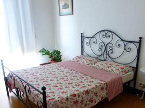 a bedroom with a bed with a red and white blanket at MY HOUSE to Cinque terre in La Spezia