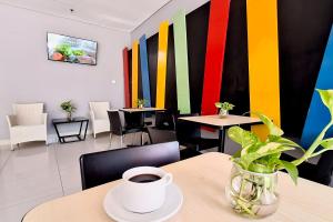 a coffee cup on a table in a restaurant at Amaris Hotel Panakkukang in Makassar