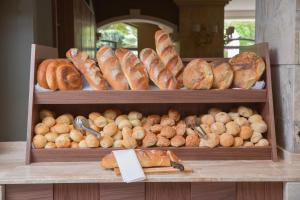 a bunch of different types of bread on display at Maritim Antonine Hotel & Spa in Mellieħa