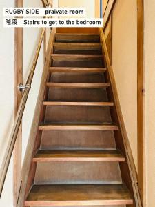 a set of stairs in a stairwell with a door at TAKIO guesthouse RUGBY SIDE in Higashi-osaka +14 photos