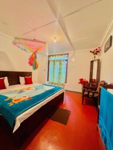 a bedroom with a large bed in a room at Dilani Adamspeak RiverStay in Adams Peak