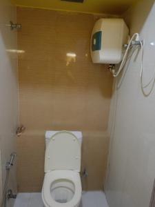 a small bathroom with a toilet in a stall at Apartment with Swimming Pool Near Kolkata Airport, Xanadu - 829 in Jāmb +12 photos