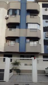 a tall building with a fence in front of it at Larus 107 in Florianópolis +20 photos