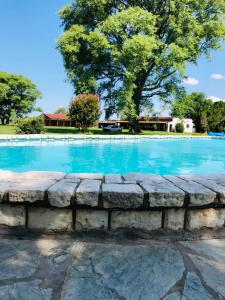 a swimming pool with a stone wall around it at Santa Regina in Progresso