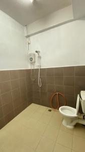 a bathroom with a toilet and a shower at Loft One Kangar in Kangar +2 photos