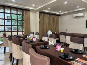 a dining room with tables and chairs at The Taj Vista Agra -walking distance to Taj Mahal in Agra