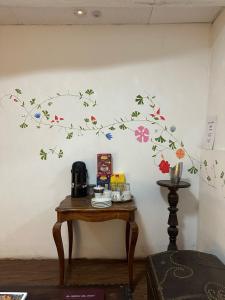 a wall with a branch with flowers on it at Casa Justina in Cusco +21 photos
