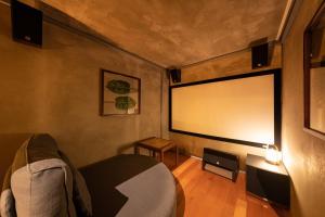 a room with a large window and a projector screen at Nihon-no-Ashitaba in Yufu +70 photos