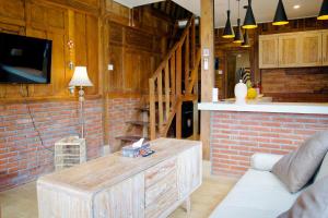 a living room with a couch and a table at Villa Batur AMED in Amed