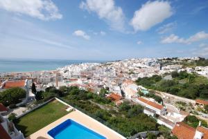 arial view of a city with a swimming pool at Sea View Downtown - Albufeira in Albufeira