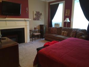 a living room with a couch and a fireplace at The Tunnicliff Inn in Cooperstown