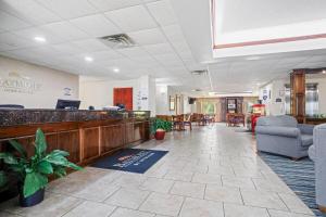 a lobby of a waiting room with chairs and a counter at Baymont by Wyndham Madisonville in Madisonville +49 photos