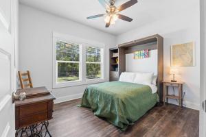 a bedroom with a bed and a ceiling fan at Reminiscing in Eastpoint +32 photos