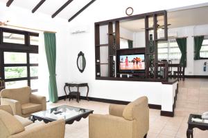 a living room with couches and a flat screen tv at Bintan Lagoon Resort in Lagoi