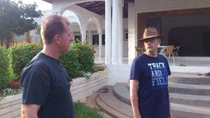 two men standing in front of a house at Egg Botanical View in Entebbe