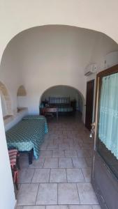 a room with a bed and a tiled floor at Tenuta Antico Leccio in Gioia del Colle