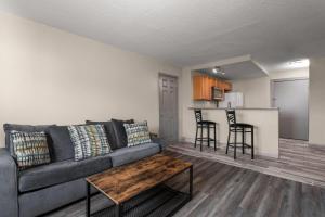 a living room with a couch and a table at Days Inn and Suites by Wyndham Hammond, IN in Hammond