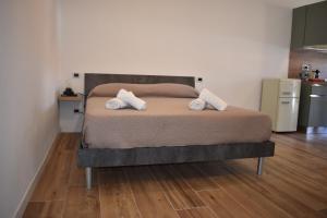 a bedroom with a bed with two pillows on it at Suite Leonardo in Magenta