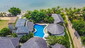 an aerial view of a resort with a pool and umbrellas at Villa Suerte in Jepara