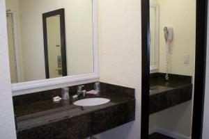a bathroom with a sink and a mirror at Budget Inn & Suites in Wall Township +18 photos