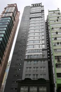 two tall buildings are next to each other at 218 Apartment in Hong Kong