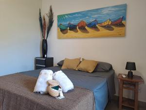 a bedroom with a bed with two towels on it at Recanto Tucuns-Guest House in Búzios +52 photos