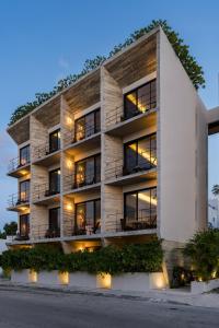an exterior view of a building with lights at The Sands Boutique Condos in Playa del Carmen