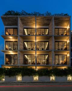 an apartment building at night with lights at The Sands Boutique Condos in Playa del Carmen