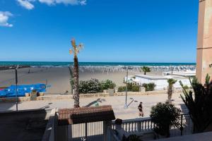 a view of the beach from the balcony of a condo at Vista d'Amare in Margherita di Savoia