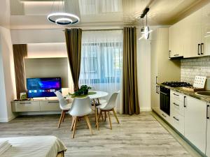 a kitchen and dining room with a table and chairs at Luxury Towers Loft in Iaşi