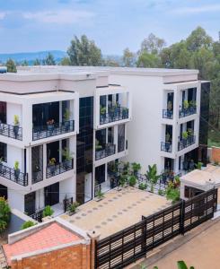 an aerial view of a white apartment building with balconies at Serene Apartments in Kigali