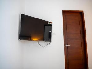 a flat screen tv hanging on a wall at FA Gardens in Ernakulam