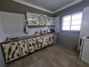 a kitchen with a sink and cabinets and a window at La Mouna 4 in Bultfontein in Bultfontein +23 photos