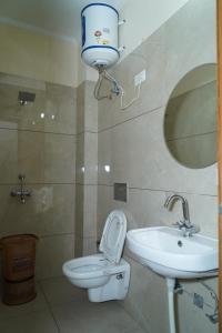 a bathroom with a toilet and a sink at Hotel Northern View in Chandīgarh