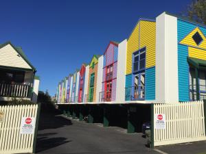 a row of colorful houses on a street at Cora Lynn - Apartment 18 in Lorne