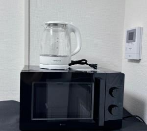 a blender sitting on top of a microwave at アークス練馬 in Tokyo