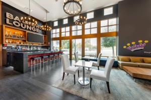 a lobby with a bar with chairs and a couch at BLVD Hotel and Studios Universal-Hollywood, an Ascend Collection Hotel in Los Angeles