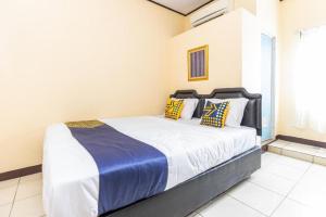 Postel nebo postele na pokoji v ubytování Hotel O Pondok Ripuji + 156 fotografií