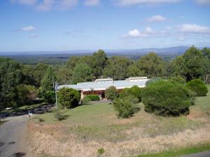 a large white house on a hill with trees at Englewood Ridge in Lovedale