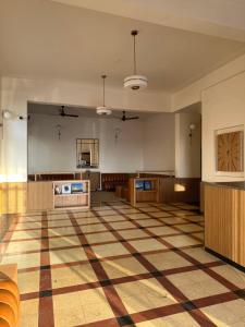 a large room with a checkered floor at Sea Green Hotel in Mumbai