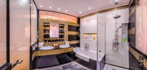 a bathroom with two sinks and a shower at BP Apartments Budapest in Budapest