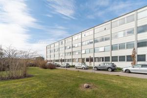 a large building with cars parked in front of it at Jagersborg alle nice Flat in Gentofte