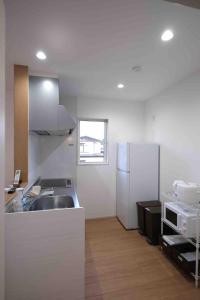 a kitchen with a sink and a refrigerator at にじいろ邸2階 in Fujiyoshida +14 photos