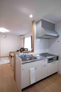 a kitchen with a sink and a counter top at にじいろ邸2階 in Fujiyoshida