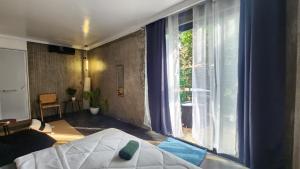 Ένα ή περισσότερα κρεβάτια σε δωμάτιο στο Pura Vida - General Luna