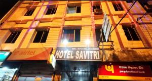 a building with a hotel sapphire sign in front of it at HOTEL SAVITRI Near Shree Baba Baidyanath Temple in Deoghar