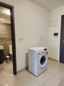 a washer and dryer sitting in a room at The PeAk Residence, Multi-Apartment by Emma in Phnom Penh